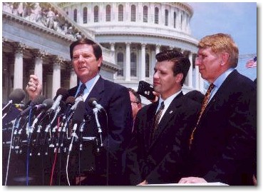 Majority Whip Tom Delay above speaks as Congressman Hostettler and RFC chairman William J. Murray look on