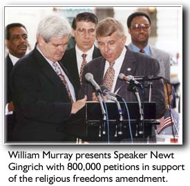 Photo of of William Murray 
presenting Newt Gingrich the petitions